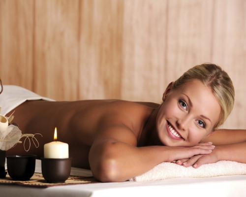 Beautiful smiling young woman relaxation in spa salon